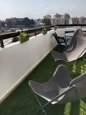 two chairs sitting on the roof of a building at Near Makenzie Beach 51 in Larnaka