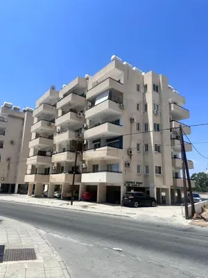 a large apartment building on the side of a street at Near Makenzie Beach 51 in Larnaka