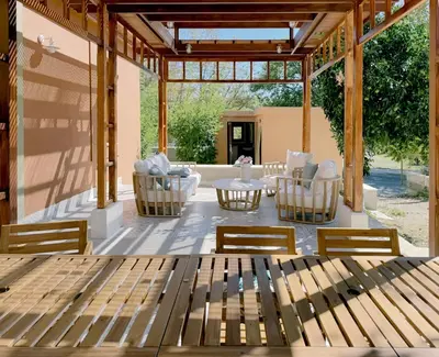 acovered patio with a table and chairs and a table at Stou Savvide - Pera Pedi Stone Manor in Perapedhi