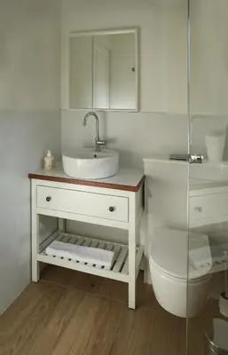 a white bathroom with a sink and a toilet at Stou Savvide - Pera Pedi Stone Manor in Perapedhi