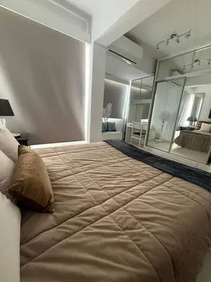 a bedroom with a large bed with a large mirror at Atalanta rooms in Larnaka