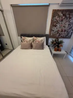 a large white bed with pillows in a room at Atalanta rooms in Larnaka