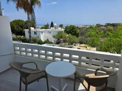 a balcony with a table and chairs and a view at Protaras Ayios Elias Maisonette in Protaras