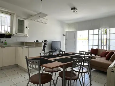 a kitchen and a table and chairs in a room at White House with Garden and BBQ in Strovolos in Nicosia