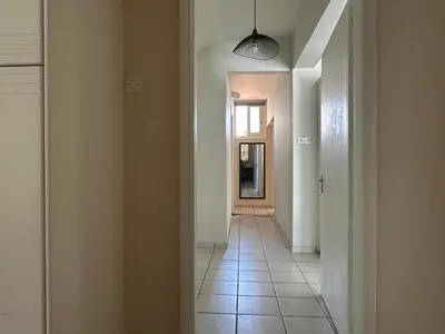an empty hallway with a hallway leading to a door at White House with Garden and BBQ in Strovolos in Nicosia
