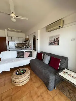 a living room with a couch and a table at Zygi Beachfront Retreat! in Zygi