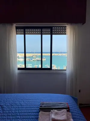 a bedroom with a window with a view of the ocean at Zygi Beachfront Retreat! in Zygi