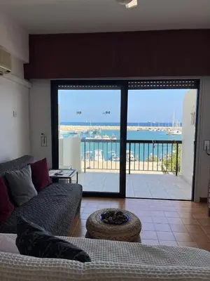 a living room with a couch and a view of the ocean at Zygi Beachfront Retreat! in Zygi