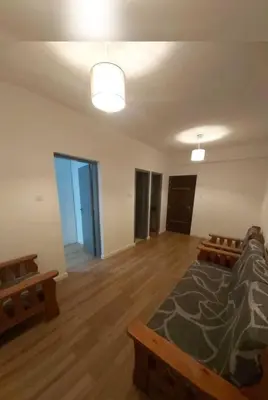 an empty room with a couch and benches in it at Однокомнатная квартира на берегу моря in Zygi