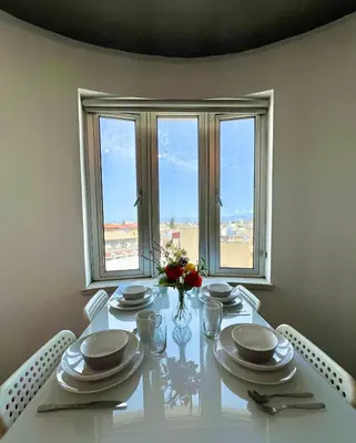 a dining room table with a view of the city at Millenia Apartment in Nicosia