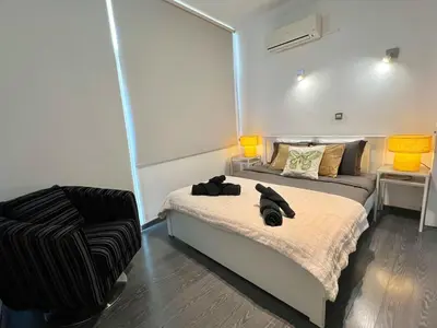 a bedroom with a bed and a chair in it at Millenia Apartment in Nicosia