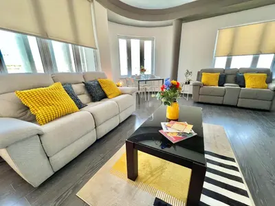 a living room with a couch and a table at Millenia Apartment in Nicosia