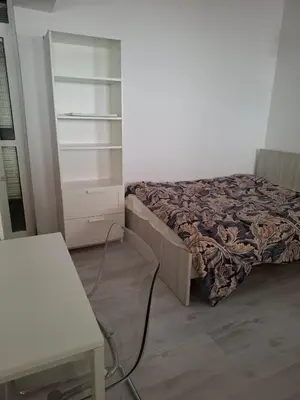 a small bedroom with a bed and a dresser at Comfortable Ground Floor Studio in Limassol in Limassol