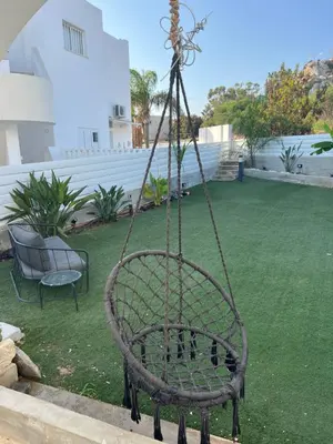 a metal swing in the middle of a yard at Protaras entire house in Protaras