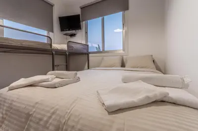 a bedroom with two beds with towels on them at Black Swan Villa in Pervolia