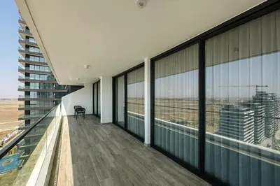 an empty balcony of an office building with large windows at 2Bedroom Apartment in Grand Sapphire Complex Featuring a Pool and Casino in Lemithou