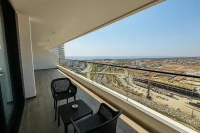 a room with two chairs and a large window at 2Bedroom Apartment in Grand Sapphire Complex Featuring a Pool and Casino in Lemithou