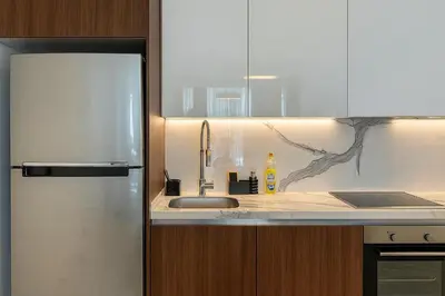 a kitchen with a sink and a refrigerator at 2Bedroom Apartment in Grand Sapphire Complex Featuring a Pool and Casino in Lemithou