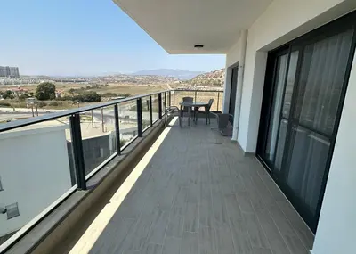a balcony of a building with a table on it at One-Bedroom Apartment in Caesar Blue Complex in Protaras