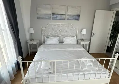 a bedroom with a white bed with two night stands at One-Bedroom Apartment in Caesar Blue Complex in Protaras