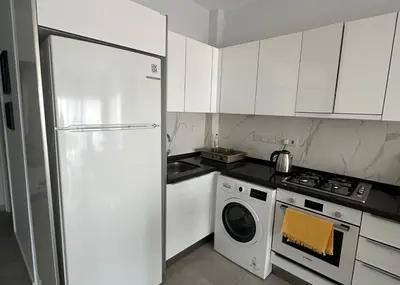 a white kitchen with a refrigerator and a stove at One-Bedroom Apartment in Caesar Blue Complex in Protaras