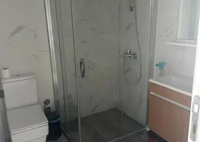 a shower with a glass door next to a toilet at One-Bedroom Apartment in Caesar Blue Complex in Protaras