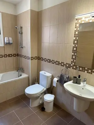 a bathroom with a toilet and a sink at Majestic Gardens 10 minutes from Larnaka Airport in Tersephanou