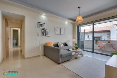 a living room with a couch and a table at Dios Ponte 102 Beachfront in Larnaka