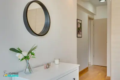 a bathroom with a sink and a mirror on the wall at Dios Ponte 102 Beachfront in Larnaka