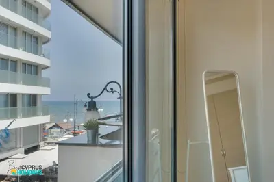 a window with a view of the ocean at Dios Ponte 102 Beachfront in Larnaka