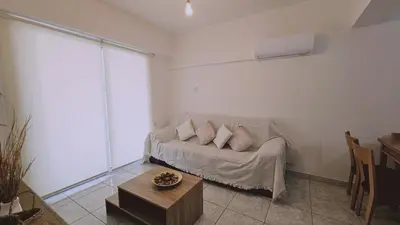 a living room with a couch and a table at STAY Miracle Apartment in Larnaka