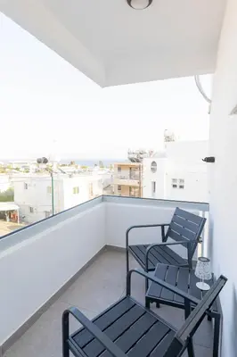 two chairs and a table on a balcony with a view at Napa Heights in Ayia Napa