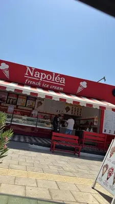 a restaurant with red benches in front of it at Sunny Escape, Protaras, Cyprus in Protaras