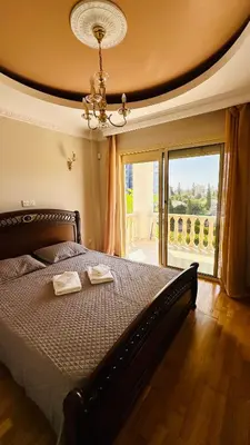 a bedroom with a bed with two towels on it at Alkeou Holiday Home in Limassol