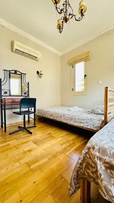 a room with two beds and a desk and a chair at Alkeou Holiday Home in Limassol