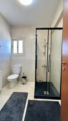 a bathroom with a glass shower with a toilet at Alkeou Holiday Home in Limassol