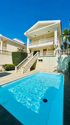 a house with a swimming pool in front of a house at Alkeou Holiday Home in Limassol