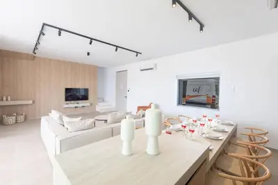 a white living room with a table and chairs at Ayia Napa Orea Villa OR2 in Ayia Napa