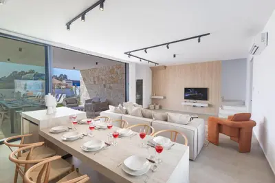 a dining room and living room with a table and chairs at Ayia Napa Orea Villa OR2 in Ayia Napa