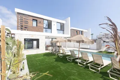 an image of a villa with chairs and a swimming pool at Ayia Napa Orea Villa OR2 in Ayia Napa