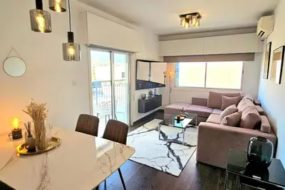 a living room with a couch and a table at Central Park Suave 2 Bed in Limassol