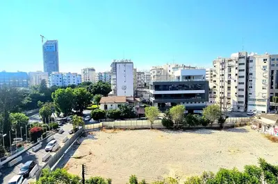 a large field in the middle of a city with buildings at Central Park Suave 2 Bed in Limassol