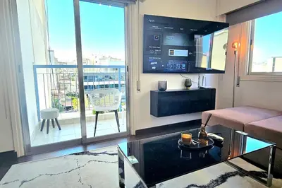 a living room with a couch and a balcony at Central Park Suave 2 Bed in Limassol