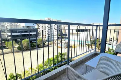 a balcony with a table and chairs and a view of a city at Central Park Suave 2 Bed in Limassol