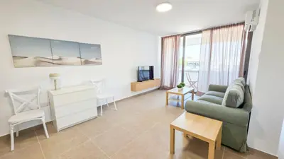 a living room with a couch and a table at Olive Dunes Stay in Larnaka
