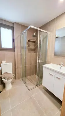 a bathroom with a shower and a toilet and a sink at Olive Dunes Stay in Larnaka