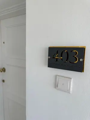 a sign on a wall next to a door at GARNET Beach Apartment in Voroklini