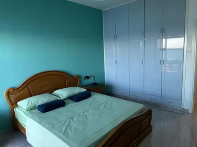 a blue bedroom with a bed with two blue pillows at GARNET Beach Apartment in Voroklini