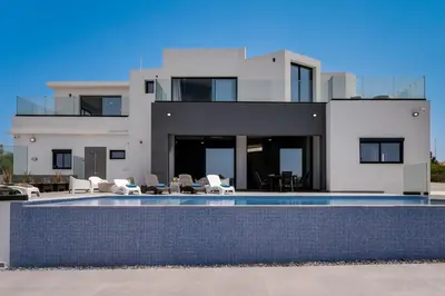 a large white house with a swimming pool at Exclusive 7-Bdr Villa with Panoramic Views & Saltwater swimming pool! in Ayia Napa