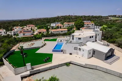 an aerial view of a large white house with a yard at Exclusive 7-Bdr Villa with Panoramic Views & Saltwater swimming pool! in Ayia Napa